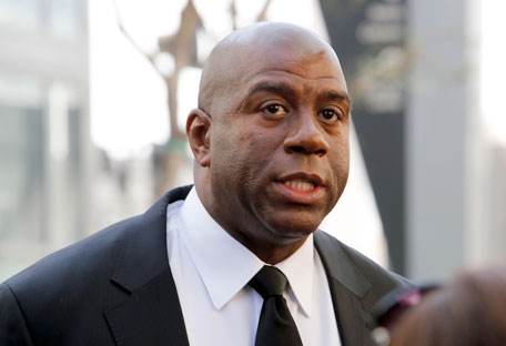 In this Feb. 21, 2013, file photo, former Los Angeles Lakers player Earvin 'Magic' Johnson arrives at a memorial service for Jerry Buss in Los Angeles. (AP)
