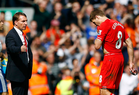 Liverpool's Steven Gerrard (right) is greeted by manager Brendan Rodgers as he leaves the pitch following their English Premier League match against Chelsea at Anfield in Liverpool, England April 27, 2014. (REUTERS)