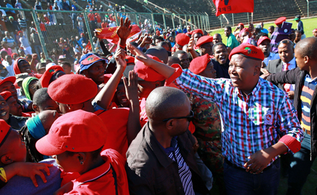 South African leader of the Economic Freedom Fighters (EFF) party and former African National Congress (ANC) Youth League leader Julius Malema (2nd R) greets supporters during an election campaign rally in Umlazi, south of Durban, South Africa, on April 27, 2014. South Africans are going to the polls for a general election on May 7, 2014. (AFP)