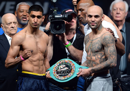 Boxers Amir Khan (left) and Luis Collazo pose during their official weigh-in at the MGM Grand Garden Arena on May 2, 2014 in Las Vegas, Nevada. (AFP)