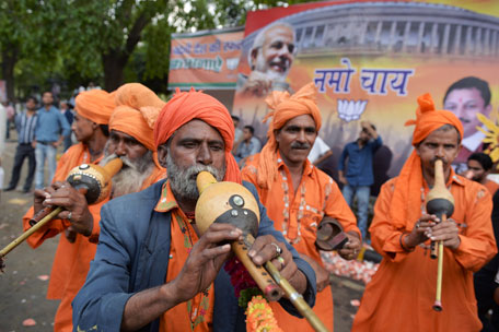 A band of Indian musicians plays music for a group of paying customers who wanted to dance as they celebrate at the Bharatiya Janata Party (BJP) headquarters in New Delhi on May 16, 2014. India's triumphant Hindu nationalists declared "the start of a new era" in the world's biggest democracy after hardline BJP leader Narendra Modi propelled them to a stunning win on a platform of revitalizing the sickly economy. (AFP)