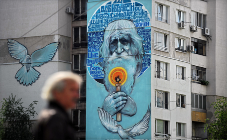 A graffiti painting on a 10-storey building dedicated to the 100-year-old Dobri Dobrev, known as "Grandpa" Dobri, is seen on this picture taken on May 8, 2014, in a suburb of Sofia. In a country ravaged by poverty and corruption, a centenarian beggar is celebrated as a saint: the ascetic "Grandpa" Dobri has spent over twenty years begging for the Church. (AFP)