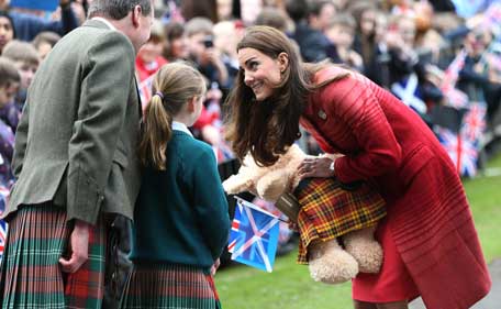 Britain's Catherine, The Duchess of Cambridge, receives a teddy bear given to her during a visit to the Macrosty Park in Crieff, some 20 kms west of Perth, Scotland on May 29, 2014. (AFP)