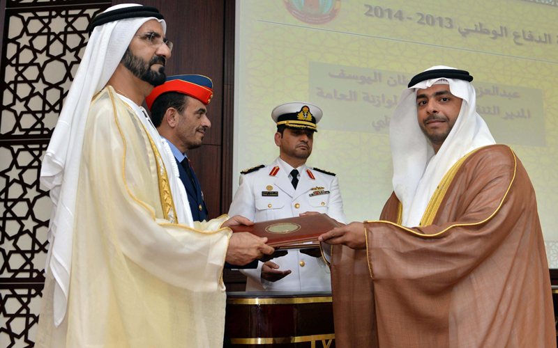 Sheikh Mohammed bin Rashid honouring a National Defence College graduate. (Wam)
