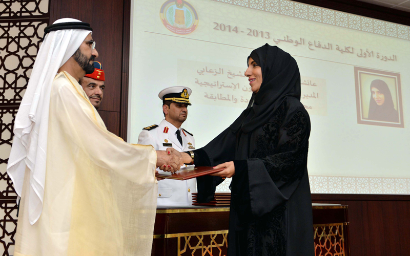 Sheikh Mohammed bin Rashid honouring a National Defence College graduate. (Wam)