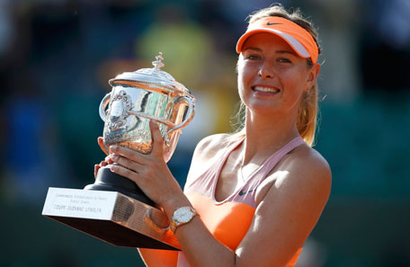 Maria Sharapova of Russia poses with the trophy during the ceremony after defeating Simona Halep of Romania during their women's singles final match to win the French Open tennis tournament at the Roland Garros stadium in Paris June 7, 2014. (REUTERS)