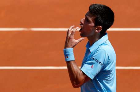 Novak Djokovic of Serbia reacts during his men's semi-final match against Ernests Gulbis of Latvia at the French Open tennis tournament at the Roland Garros stadium in Paris June 6, 2014. (REUTERS)