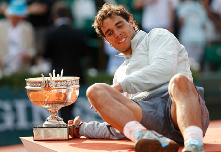 Rafael Nadal of Spain poses with the trophy during the ceremony after defeating Novak Djokovic of Serbia during their men's singles final match of the French Open Tennis tournament at the Roland Garros stadium in Paris June 8, 2014. (REUTERS)