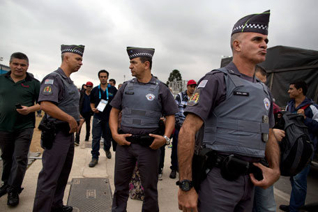Police stand guard outside Arena Corinthians stadium in Sao Paulo, Brazil, Wednesday, June 11, 2014. (AP)