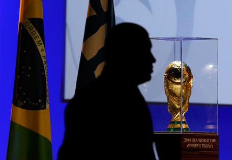 A security man stands next to the FIFA World Cup trophy during the 65th FIFA Congress, held ahead of the 2014 World Cup, in Sao Paulo, June 11, 2014. (REUTERS)