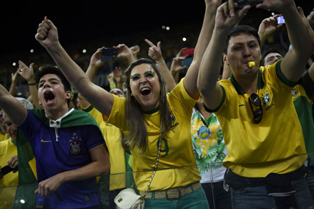 Brazilian fans celebrate after Brazil won their Group A football match against Croatia at the Corinthians Arena in Sao Paulo on June 12, 2014 during the opening match of the 2014 FIFA World Cup.  (AFP)
