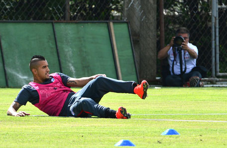 Chile's national football team midfielder Arturo Vidal rests on the ground during a training session at the Toca da Raposa training ground in Belo Horizonte, on June 11, 2014. (AFP)