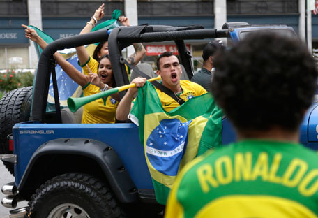 Brazil soccer fans celebrate on the street in downtown Framingham, Mass., after Brazil defeated Croatia in the first 2014 World Cup soccer match, Thursday, June 12, 2014. (AP)