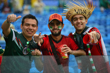 Mexican football fans cheer for their team as they wait for the start of a Group A football match between Mexico and Cameroon at the Dunas Arena in Natal during the 2014 FIFA World Cup on June 13, 2014. (AFP)