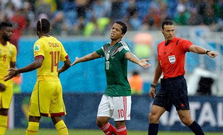 Mexico's Giovani dos Santos (centre) reacts during the group A World Cup match between Mexico and Cameroon in the Arena das Dunas in Natal, Brazil, Friday, June 13, 2014. (AP)