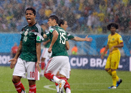 Mexico's Giovani dos Santos reacts after his goal was disallowed during the group A World Cup soccer match between Mexico and Cameroon in the Arena das Dunas in Natal, Brazil, Friday, June 13, 2014. (AP)