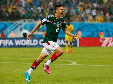 Mexico's Oribe Peralta celebrates his goal against Cameroon during their 2014 World Cup Group A soccer match at the Dunas arena in Natal June 13, 2014. (REUTERS)