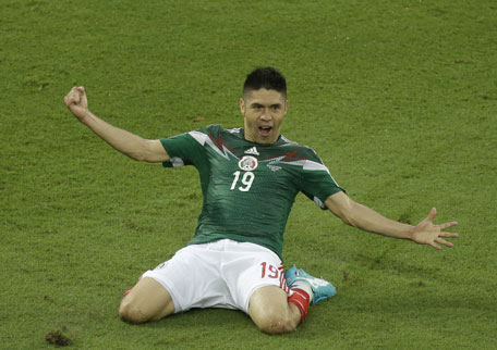 Mexico's Oribe Peralta celebrates after scoring during the group A World Cup soccer match between Mexico and Cameroon in the Arena das Dunas in Natal, Brazil, Friday, June 13, 2014. (AP)