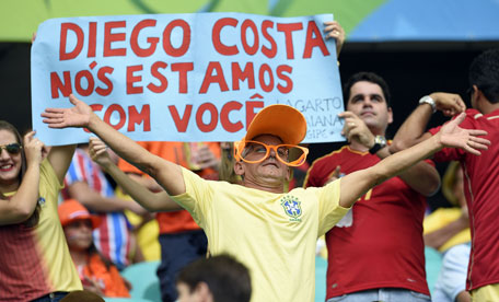 Fans hold a placard in support of Spain's forward Diego Costa before the start of a Group B football match between Spain and the Netherlands at the Fonte Nova Arena in Salvador during the 2014 FIFA World Cup on June 13, 2014. (AFP)