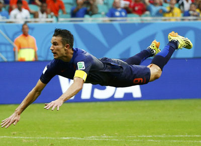 Robin van Persie of the Netherlands heads to score against Spain during their 2014 World Cup Group B soccer match at the Fonte Nova arena in Salvador June 13, 2014. (Reuters)