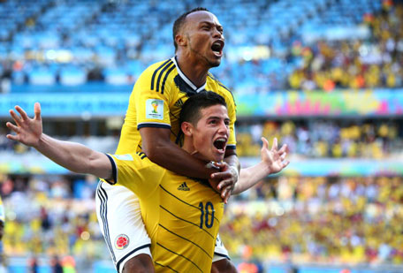 James Rodriguez of Colombia celebrates scoring his teams third goal with Juan Camilo Zuniga during the 2014 FIFA World Cup Brazil Group C match between Colombia and Greece at Estadio Mineirao on June 14, 2014 in Belo Horizonte, Brazil. (GETTY)