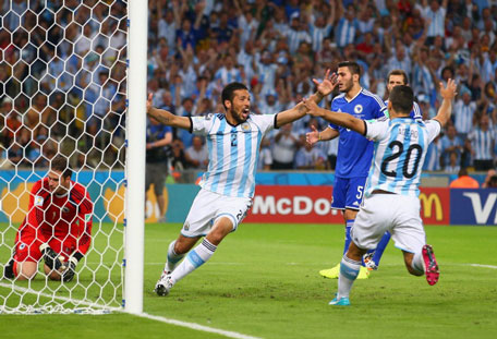 Ezequiel Garay (second left) and Sergio Aguero (irhgt) of Argentina celebrate their team's first goal, an own goal off Sead Kolasinac (second right) of Bosnia and Herzegovina past goalkeeper Asmir Begovic during the 2014 FIFA World Cup Brazil Group F match between Argentina and Bosnia-Herzegovina at Maracana on June 15, 2014 in Rio de Janeiro, Brazil. (GETTY)