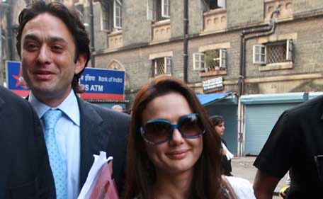 (FILES) In this photograph taken on December 2, 2010, Indian Industrialist Ness Wadia (L) and Bollywood actress Preity Zinta leave the High Court in Mumbai after filing a petition relating to an Indian sports team. (AFP)