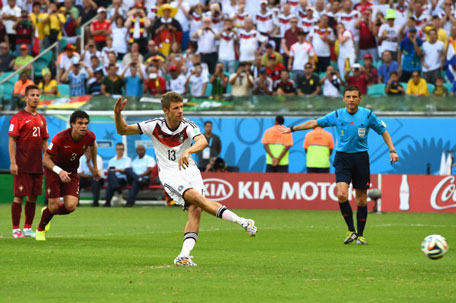 Thomas Mueller of Germany shoots and scores his team's first goal on a penalty kick during the 2014 FIFA World Cup Brazil Group G match between Germany and Portugal at Arena Fonte Nova on June 16, 2014 in Salvador, Brazil. (GETTY)