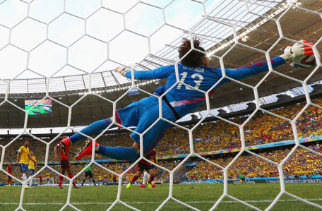 Guillermo Ochoa of Mexico dives to make a save during the 2014 FIFA World Cup Brazil Group A match between Brazil and Mexico at Castelao on June 17, 2014 in Fortaleza, Brazil. (GETTY)