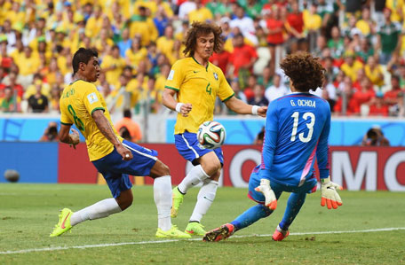 Guillermo Ochoa of Mexico makes a save from Paulinho of Brazil as David Luiz looks on during the 2014 FIFA World Cup Brazil Group A match between Brazil and Mexico at Castelao on June 17, 2014 in Fortaleza, Brazil. (GETTY)