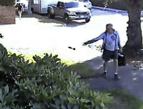 File image from a security video provided by Philip Lao, shows Dennis Kneier, the mayor of San Marino, Calif, tosses a bag of dog waste onto the property of his Lao, in San Marino, Calif.   The Pasadena Star-News reports San Marino Mayor Dennis Kneier resigned Tuesday, June 17, 2014 after outcry from residents who say he smeared their image. (AP)