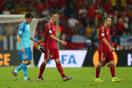 A dejected Iker Casillas, Fernando Torres and Andres Iniesta of Spain look on after being defeated by Chile 2-0 during the 2014 FIFA World Cup Brazil Group B match at Maracana on June 18, 2014 in Rio de Janeiro, Brazil. (GETTY)