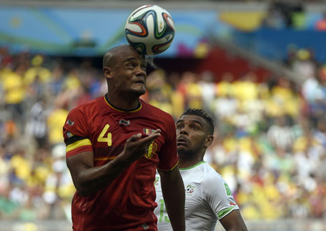 Algeria's forward El Arabi Soudani (right) and Belgium's defender Vincent Kompany vie for the ball during a Group H football match at the Mineirao Stadium in Belo Horizonte during the 2014 FIFA World Cup on June 17, 2014. (AFP)
