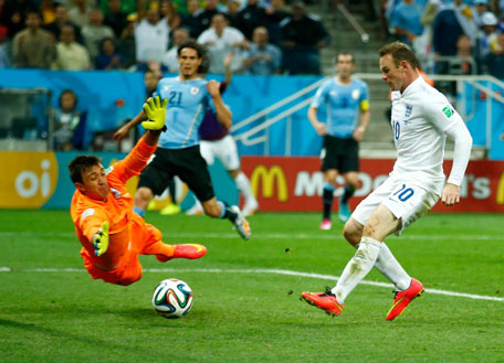 Wayne Rooney of England scores his team's first goal past Fernando Muslera of Uruguay during the 2014 FIFA World Cup Brazil Group D match between Uruguay and England at Arena de Sao Paulo on June 19, 2014 in Sao Paulo, Brazil. (GETTY)