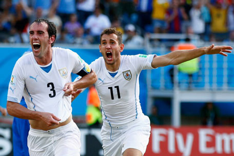 Diego Godin (left) of Uruguay celebrates scoring his team's first goal during the 2014 FIFA World Cup Brazil Group D match between Italy and Uruguay at Estadio das Dunas on June 24, 2014 in Natal, Brazil. (GETTY)