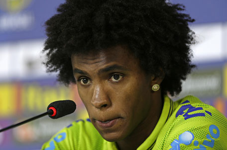 Brazil's Willian looks on during a news conference after a training session, in Teresopolis, Brazil, Wednesday, June 25, 2014. Brazil will face Chile on June 28 in the round of 16 of the 2014 soccer World Cup. (AP)