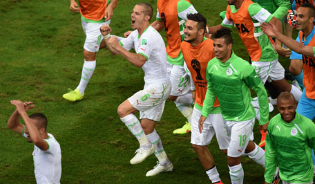 Algeria's players celebrate after their victory in the Group H football match between Algeria and Russia at The Baixada Arena in Curitiba on June 26, 2014, during the 2014 FIFA World Cup. (AFP)