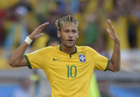 Brazil's forward Neymar celebrates after scoring during the penalty shoot out after extra-time in the Round of 16 football match between Brazil and Chile at The Mineirao Stadium in Belo Horizonte during the 2014 FIFA World Cup on June 28, 2014. (AFP)