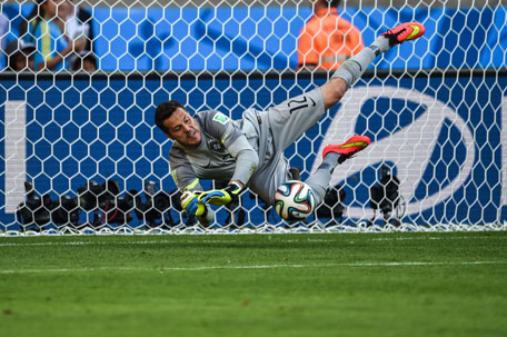 Brazilian goalie Julio Cesar saves a shot on goal during a penalty shoot out after extra-time in the Round of 16 football match at The Mineirao Stadium in Belo Horizonte during the 2014 FIFA World Cup on June 28, 2014. (AFP)