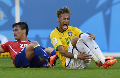 Brazil's forward Neymar (right) reacts after being fouled by Chile's midfielder Charles Aranguiz during the round of 16 football match between Brazil and Chile at The Mineirao Stadium in Belo Horizonte during the 2014 FIFA World Cup on June 28, 2014. (AFP)