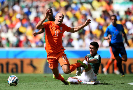 Arjen Robben of the Netherlands is tackled by Hector Moreno of Mexico during the 2014 FIFA World Cup Brazil Round of 16 match between Netherlands and Mexico at Estadio Castelao on June 29, 2014 in Fortaleza, Brazil. (GETTY)