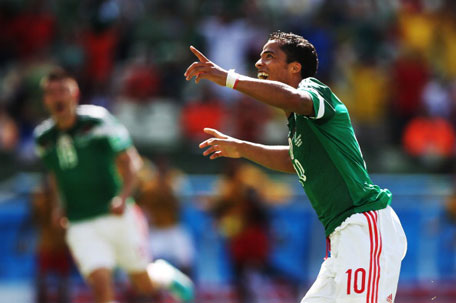 Giovani dos Santos of Mexico celebrates after he scores during the Round of 16 match of the 2014 World Cup between Netherlands and Mexico at the Estadio Castelao on June 29, 2014 in Fortaleza, Brazil. (GETTY)