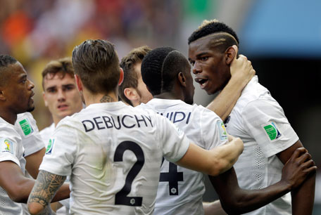 France's Paul Pogba (right) celebrates with teammates after scoring his team's first goal during the World Cup round of 16 match between France and Nigeria at the Estadio Nacional in Brasilia, Brazil, Monday, June 30, 2014. (AP)
