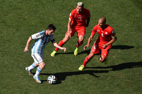 Lionel Messi of Argentina controls the ball against Valon Behrami (centre) and Gokhan Inler of Switzerland during the 2014 FIFA World Cup Brazil Round of 16 match between Argentina and Switzerland at Arena de Sao Paulo on July 1, 2014 in Sao Paulo, Brazil. (GETTY)