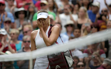 Maria Sharapova of Russia reacts after being defeated by Angelique Kerber of Germany in their women's singles tennis match at the Wimbledon Tennis Championships, in London July 1, 2014. (REUTERS)