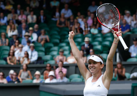 Simona Halep of Romania celebrates as she defeats Sabine Lisicki of Germany in their women's singles quarter-final at the All England Lawn Tennis Championships in Wimbledon, London, Wednesday, July 2, 2014. (AP)