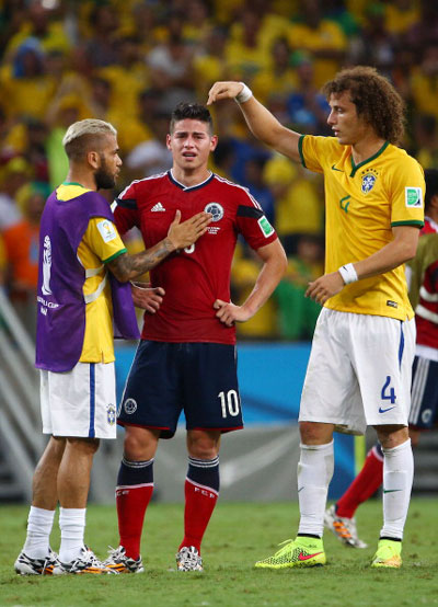 Dani Alves (left) and David Luiz of Brazil console James Rodriguez of Colombia after Brazil's 2-1 win during the 2014 FIFA World Cup Brazil Quarter Final match between Brazil and Colombia at Castelao on July 4, 2014 in Fortaleza, Brazil. (GETTY)