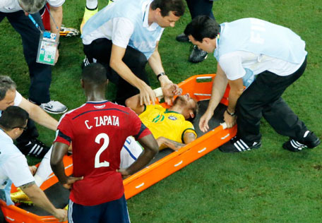 Neymar of Brazil receives treatment in a stretcher as Cristian Zapata of Colombia looks on during the 2014 FIFA World Cup Brazil Quarter Final match between Brazil and Colombia at Castelao on July 4, 2014 in Fortaleza, Brazil. (GETTY)