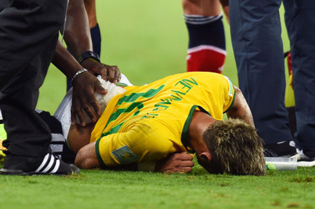 Neymar of Brazil receives treatment after a challenge during the 2014 FIFA World Cup Brazil Quarter Final match between Brazil and Colombia at Castelao on July 4, 2014 in Fortaleza, Brazil. (GETTY)