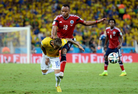 Neymar of Brazil is challenged by Juan Camilo Zuniga of Colombia during the 2014 FIFA World Cup Brazil Quarter Final match between Brazil and Colombia at Castelao on July 4, 2014 in Fortaleza, Brazil. (GETTY)